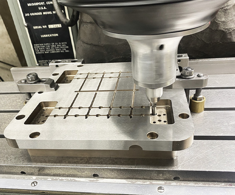 Jig grinding a metal plate